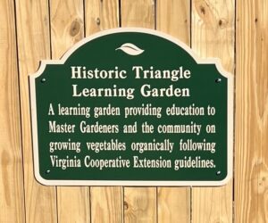 historical triangle learning garden sign on garden gate