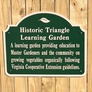 historical triangle learning garden sign on garden gate