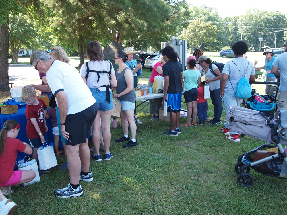 family and children at pollinator palooza event tables