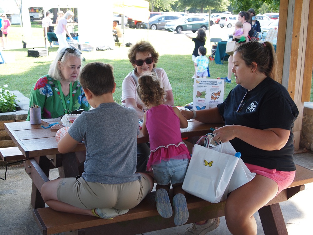 Master gardeners doing crafts with children at pollinator palooza event
